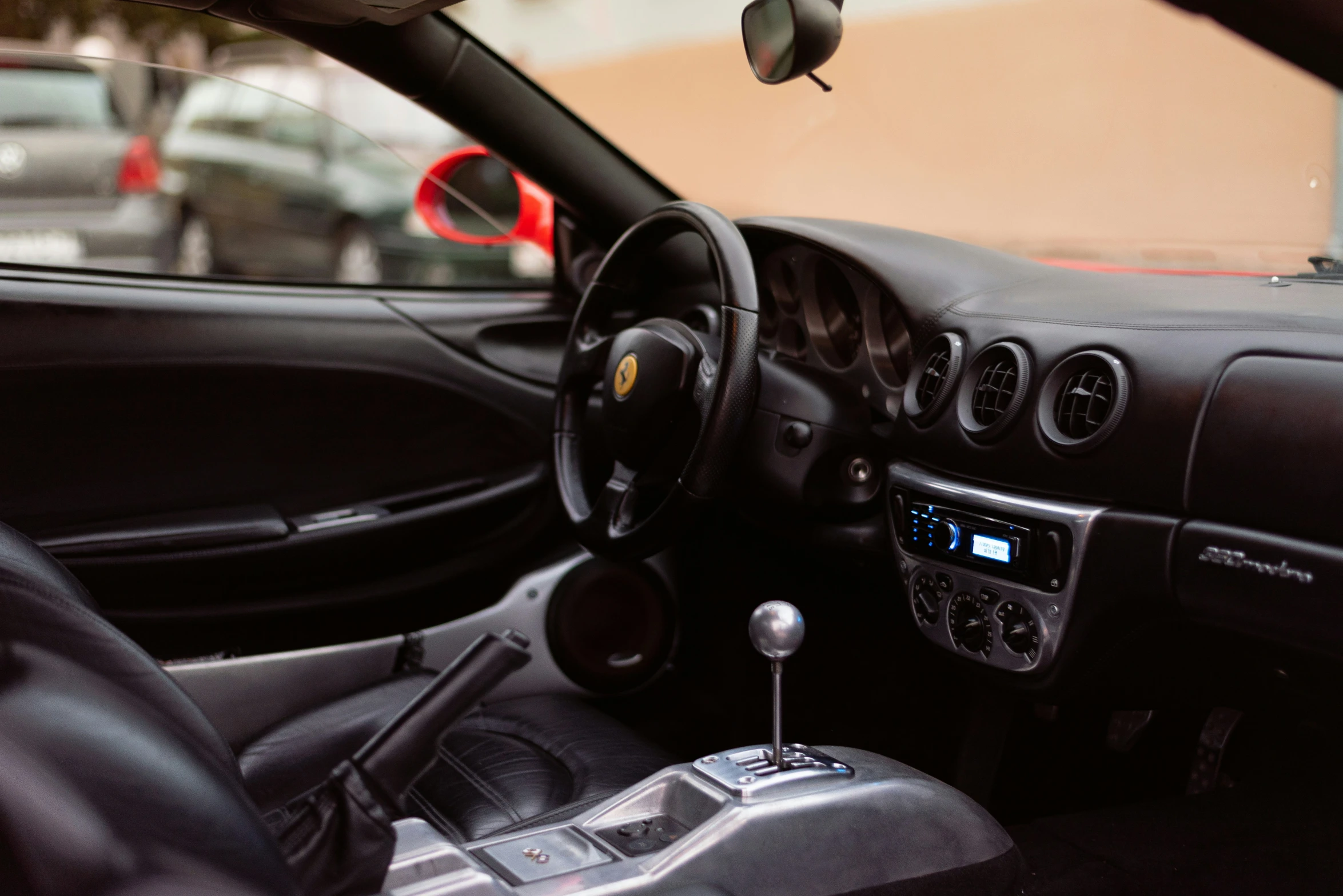 a car interior with the door open and dashboard light on