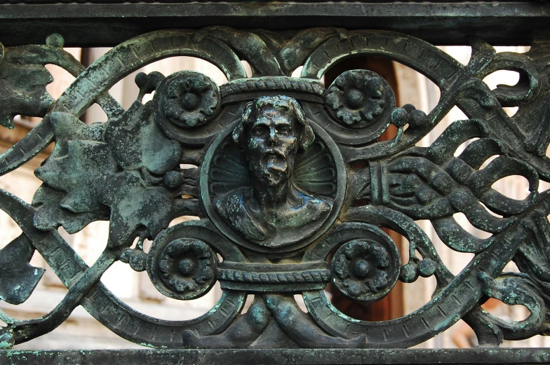 a black ironwork with a portrait of an elderly man