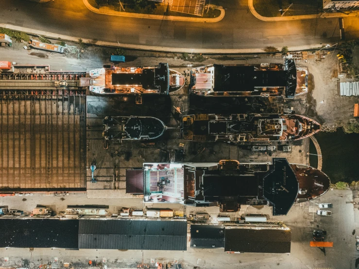 an overhead s of trucks on the ground next to some buildings