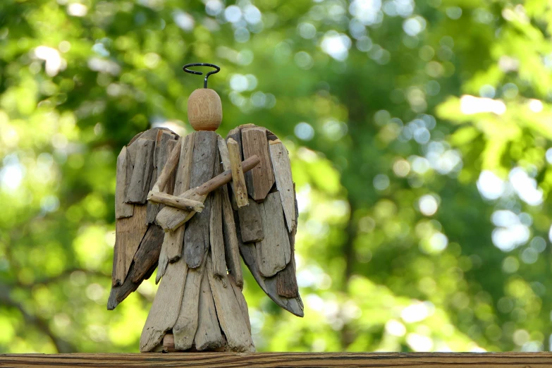 a statue of an angel is made out of drift wood