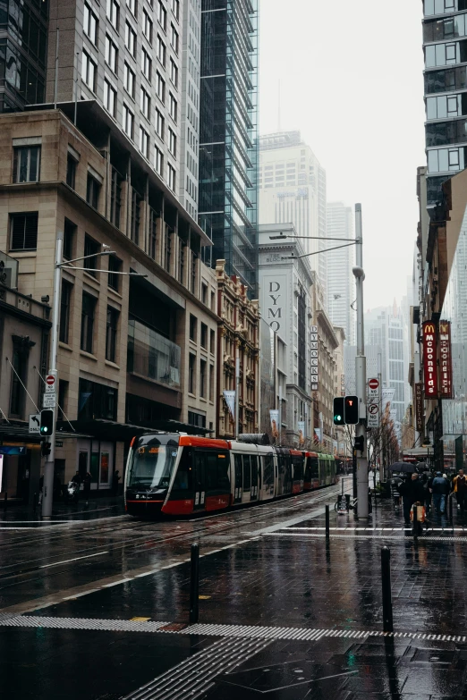 a train passing through an intersection in the rain