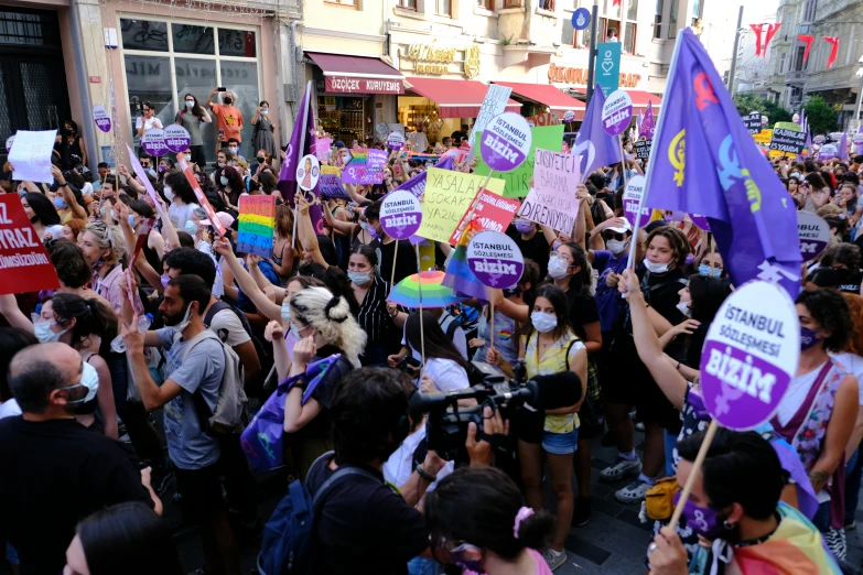 a crowd of people with signs protesting outside