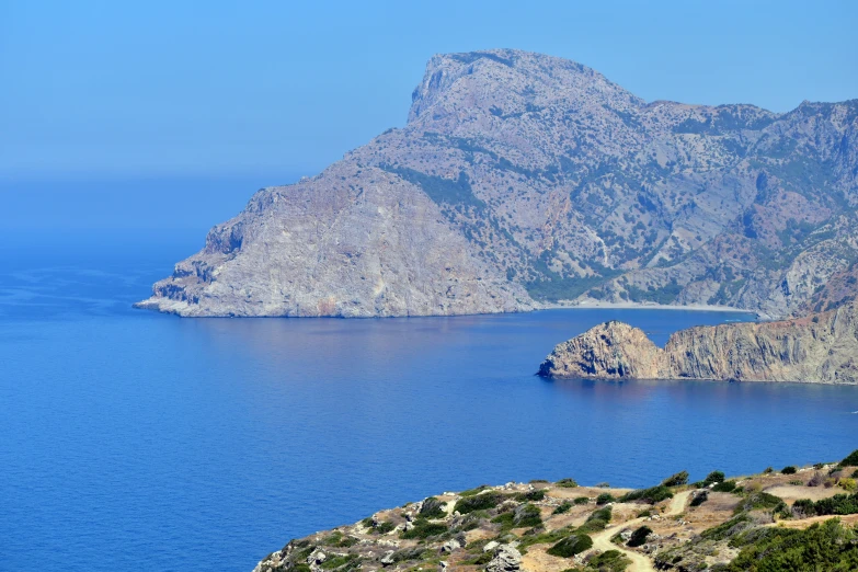 a lake near mountains with blue water