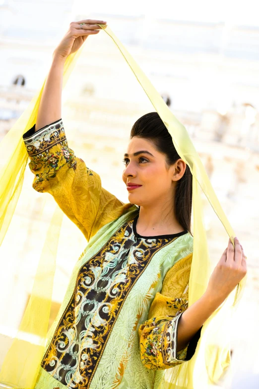 a woman with black hair wearing a yellow dress