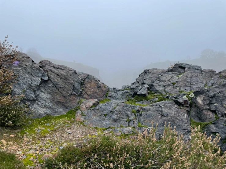 the yellow bench is sitting on the rocky hillside