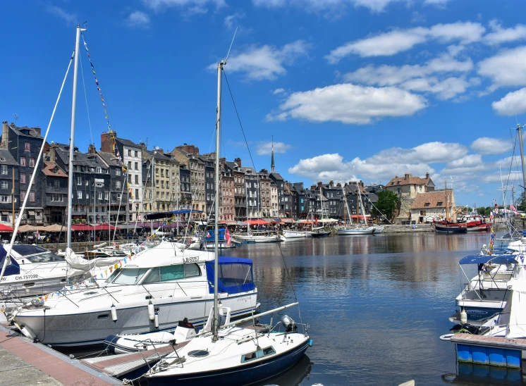 small boats are docked on the river in front of old buildings