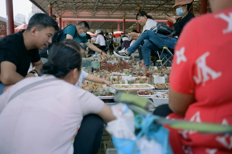 an indoor food court is covered with many people eating