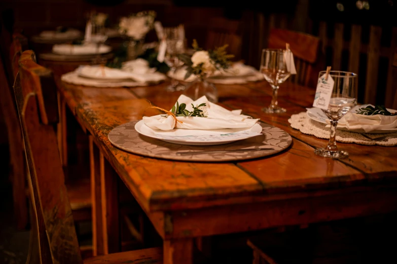 dinner table with several plates and silverware, along with two wine glasses