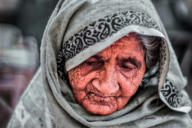 old woman with wrinkles and scarves wearing scarf