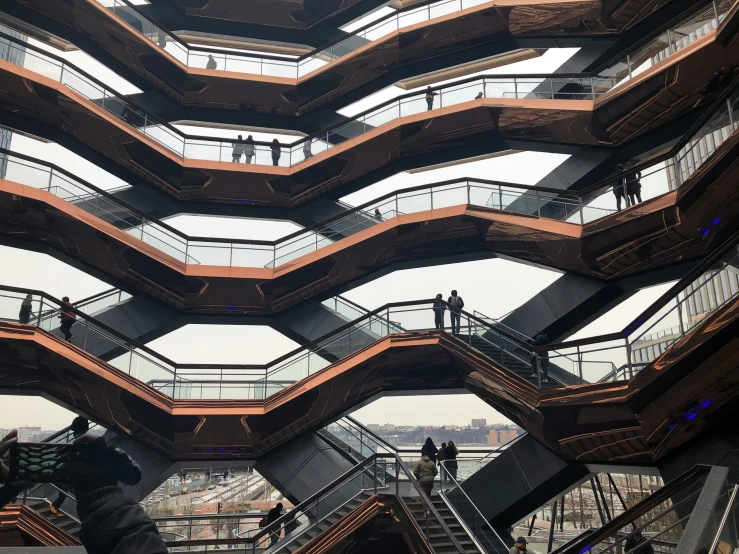 people are seen walking down the escalator in a building