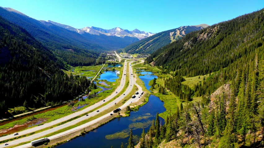 a road winding around a bend in a valley