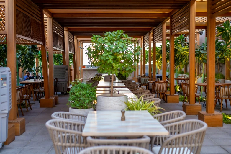 a outdoor restaurant with white wicker chairs