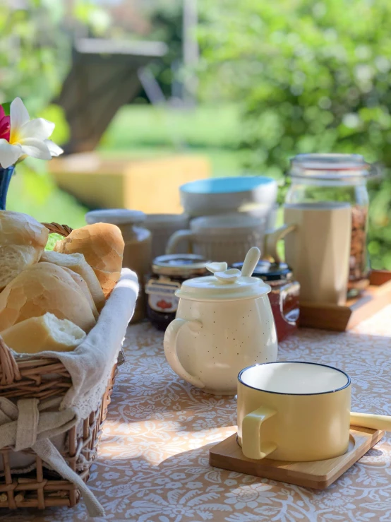 a table full of food and tea sits outside