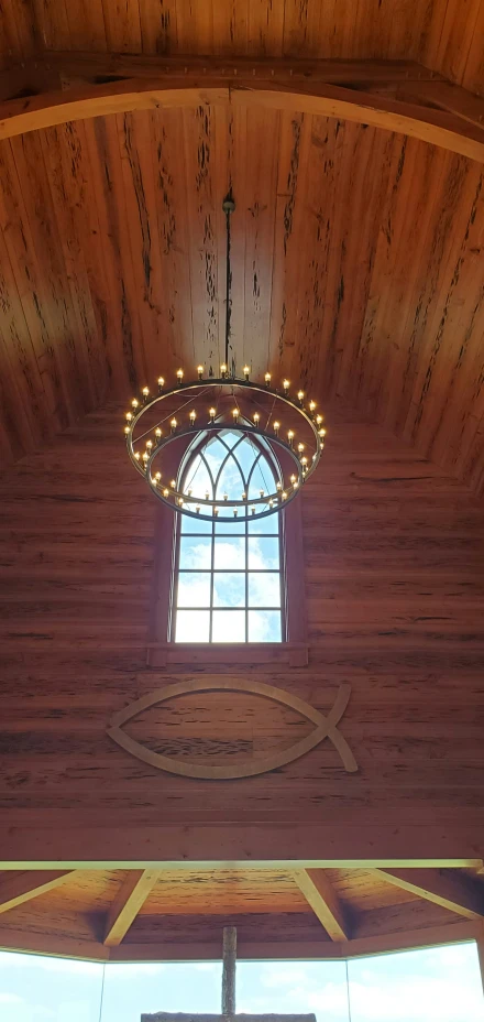 a wooden room has an open circle window