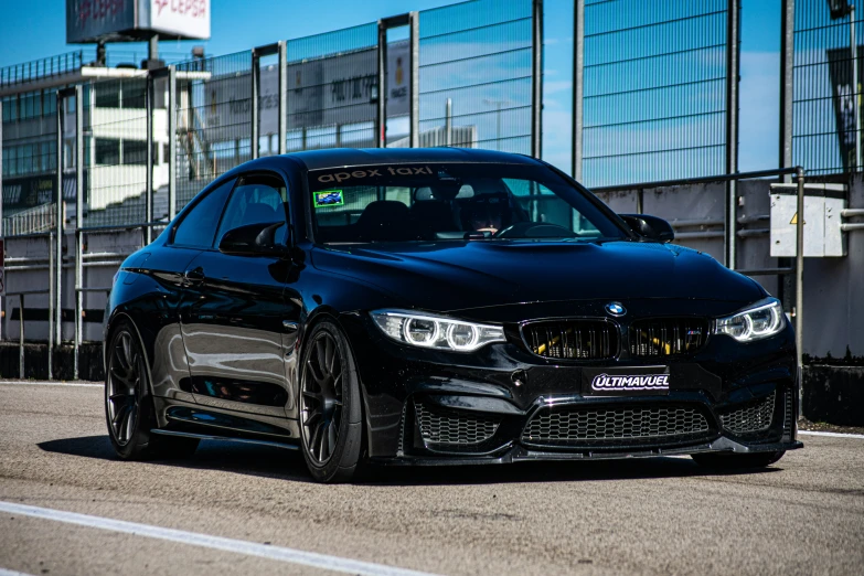 a black bmw with custom stickers on the front