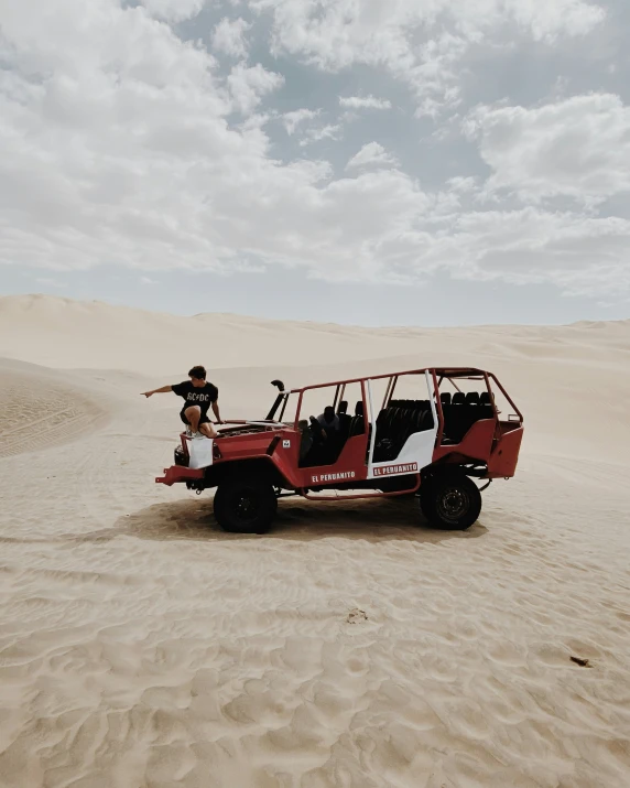 the two guys are standing next to an off road car