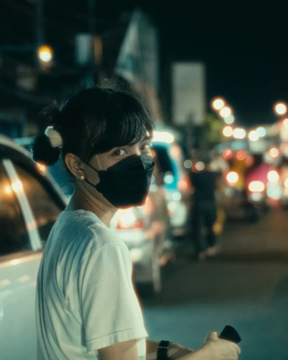 woman with a black mask on holding a bicycle