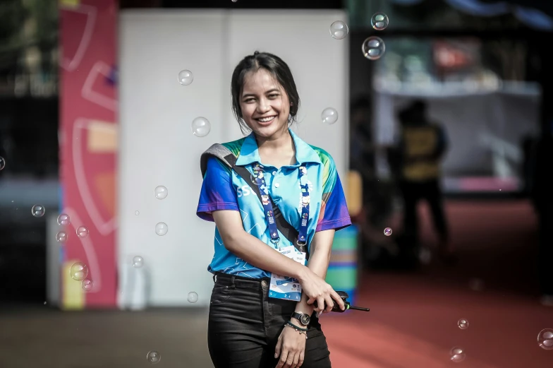 a girl is walking with water bubbles in front of her