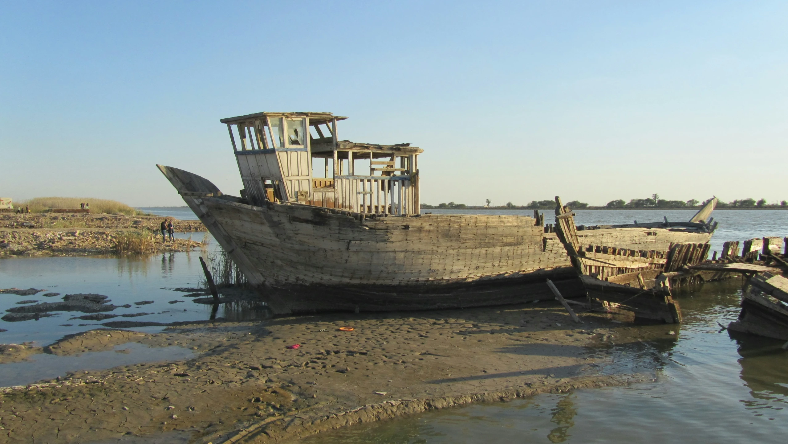 two small boats sit in the sand