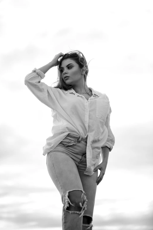 a woman in jean shorts is leaning up against a railing