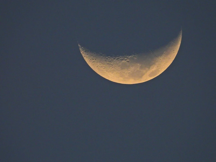 the half moon is shown in the dark sky