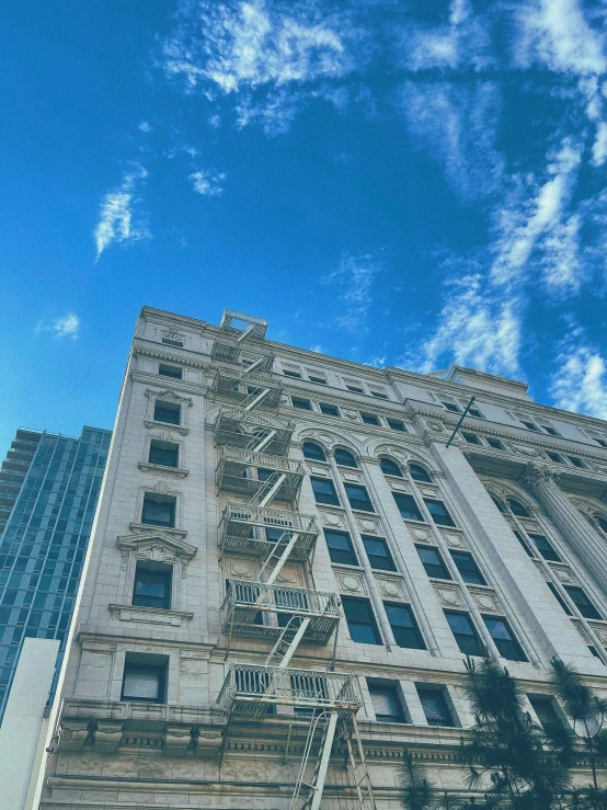 a building with lots of windows on it's side and a clock tower below