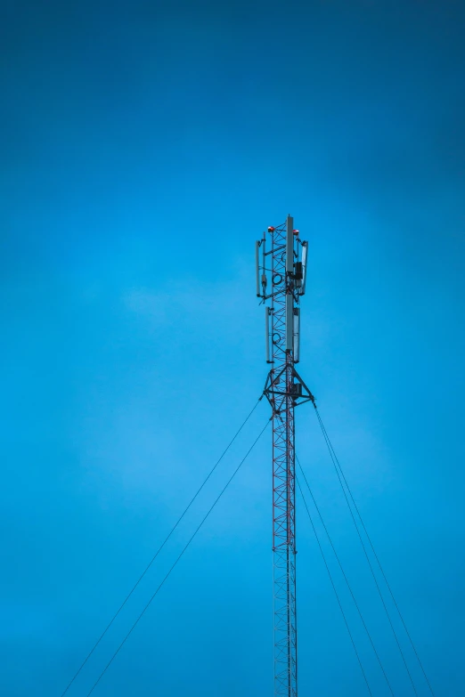 a cellular phone tower on a blue sky