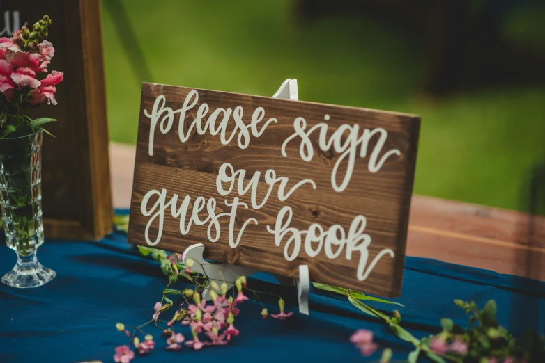 a wooden sign sitting on top of a table