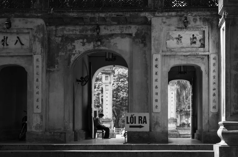 an entrance gate with arches and a sign