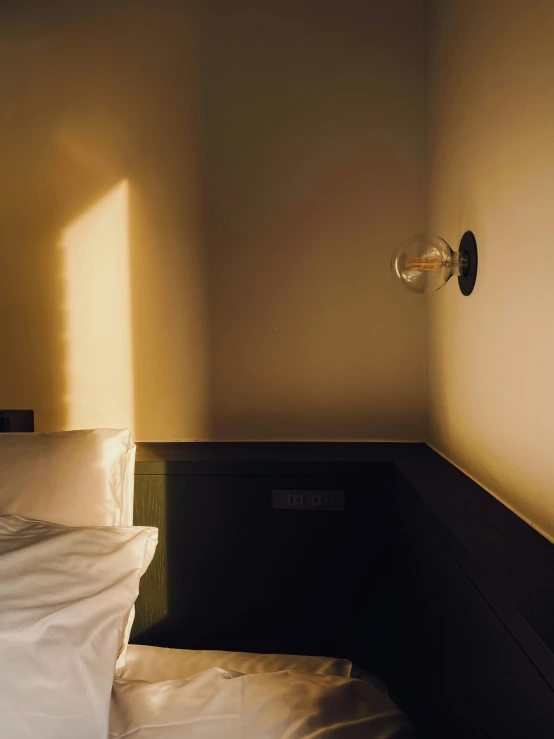 a white bed and pillows on a small room