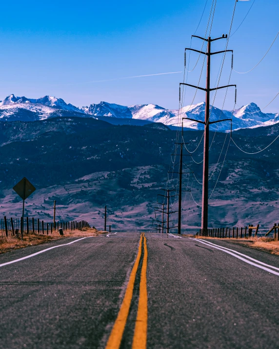 a view of an empty highway near mountains