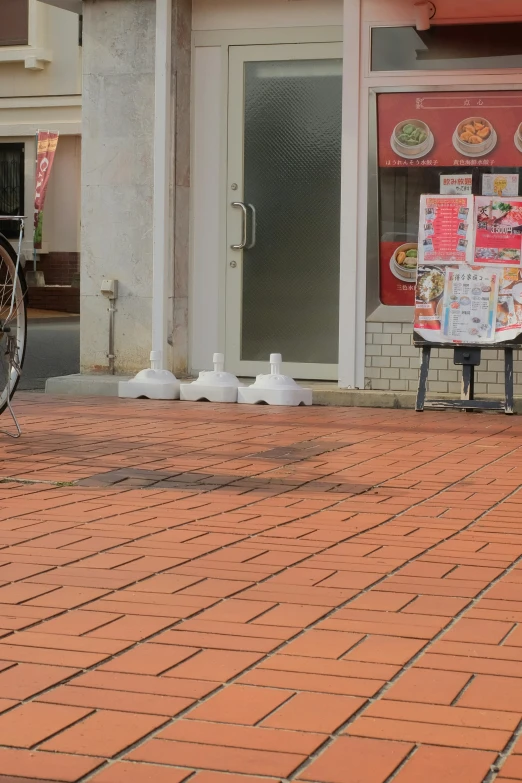 a person walking with a bicycle near buildings