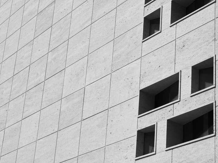 black and white pograph of three windows on a building