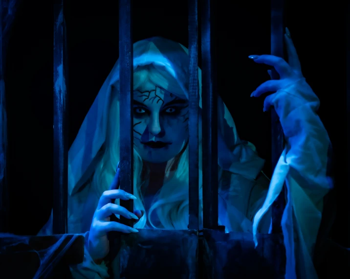 a woman in makeup and nun makeup behind bars