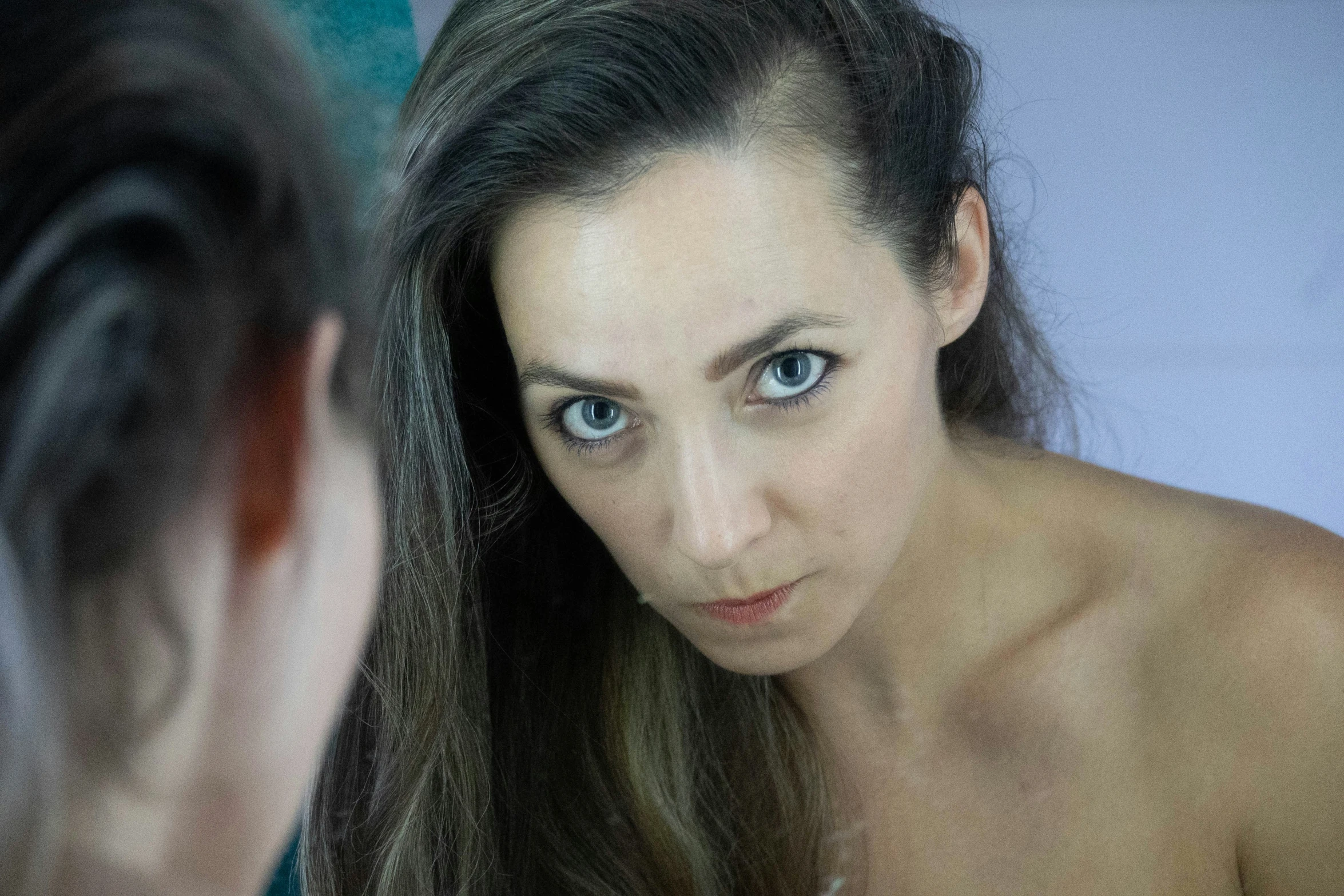 young woman brushing her hair in the bathroom