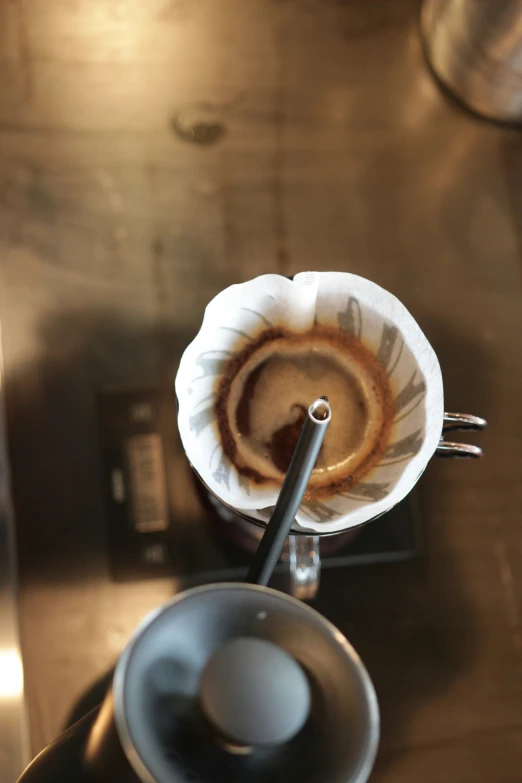 the bottom portion of a cup with coffee in it