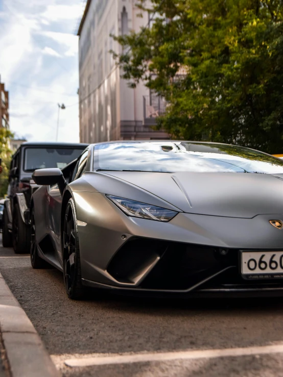 a large gray sport car is parked on the side of the road