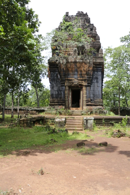 an old stone structure that looks to be in the jungle