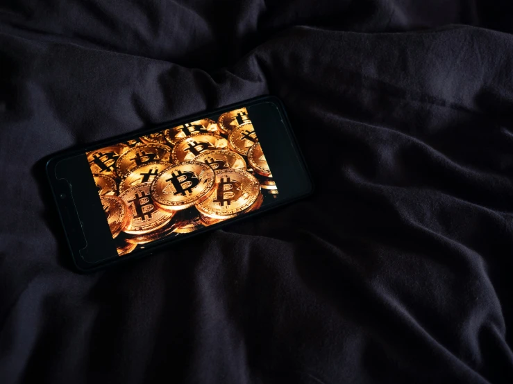 an iphone screen that is on some kind of bed