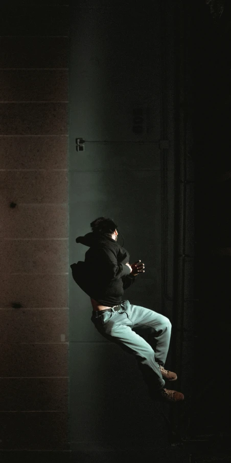 a man playing guitar in the dark