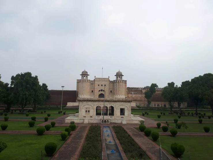 a very large building with a few trees on the sides