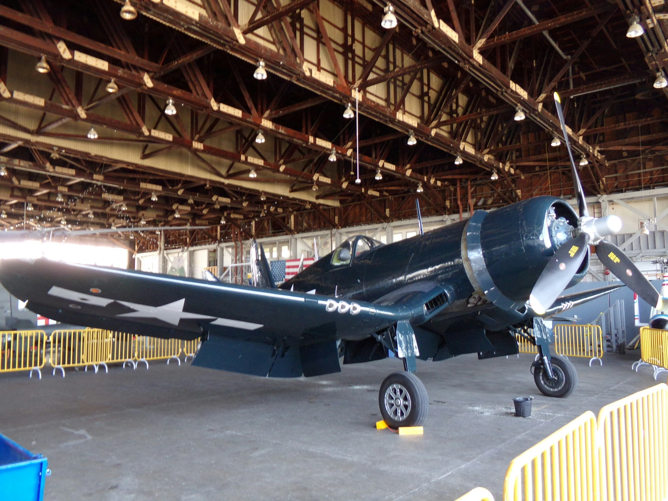 an old propeller plane sitting in a hangar