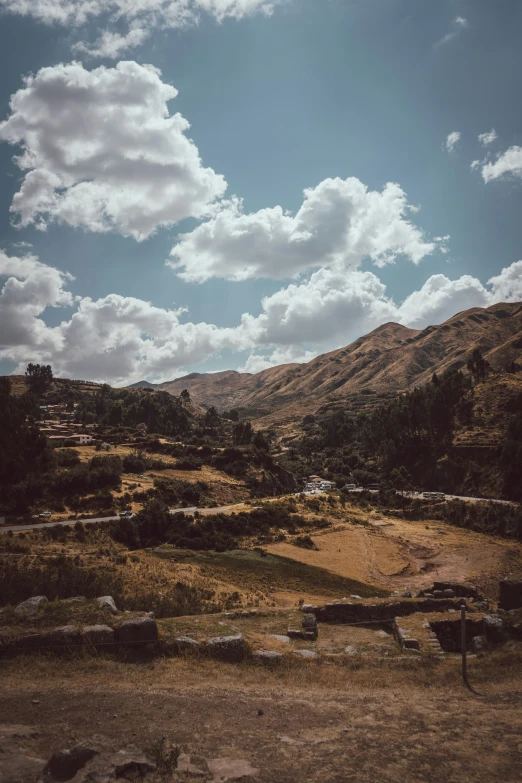 the mountains and trees are shown under a blue cloudy sky