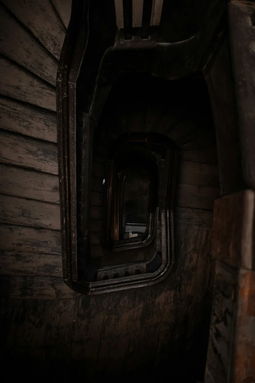 a room in the shape of a tunnel with wood slats