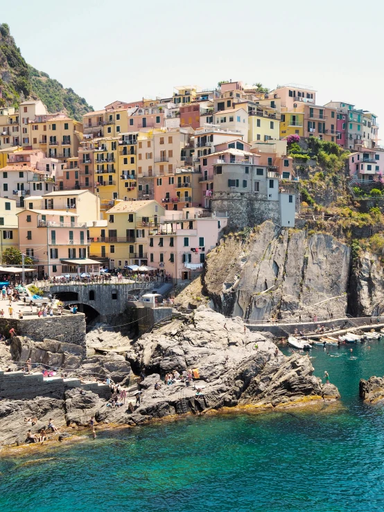 an image of a cliff side town with houses on it