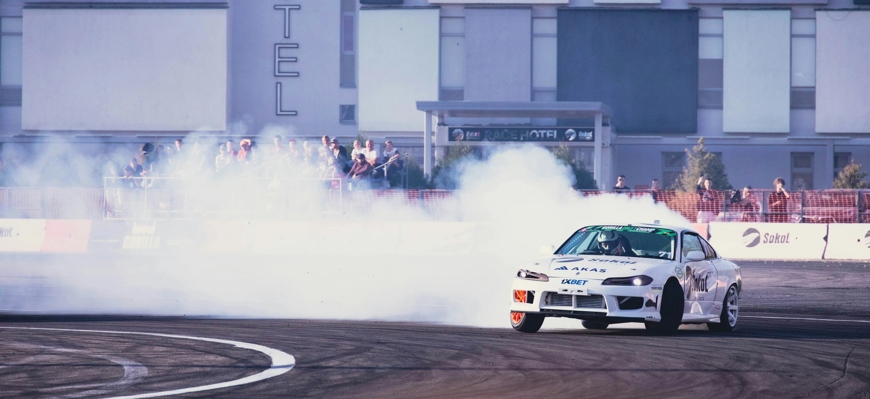 the drifting race car is being fired by the crowd