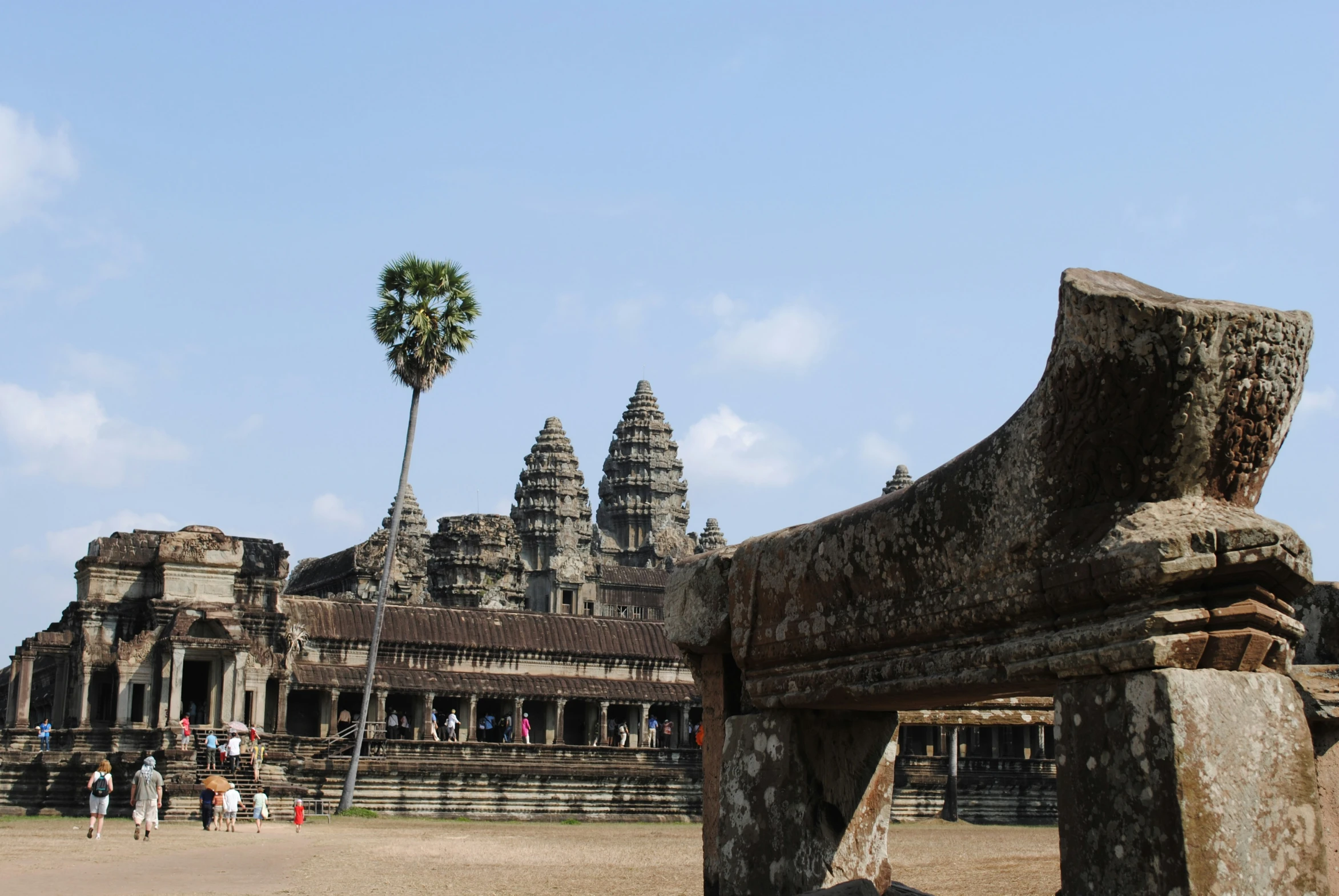 an ancient structure with palm trees on the side