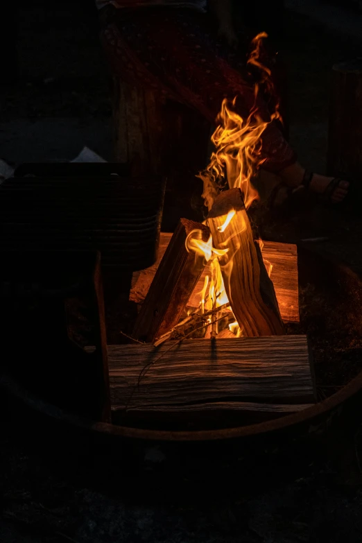 a wood stove with some fire going into it