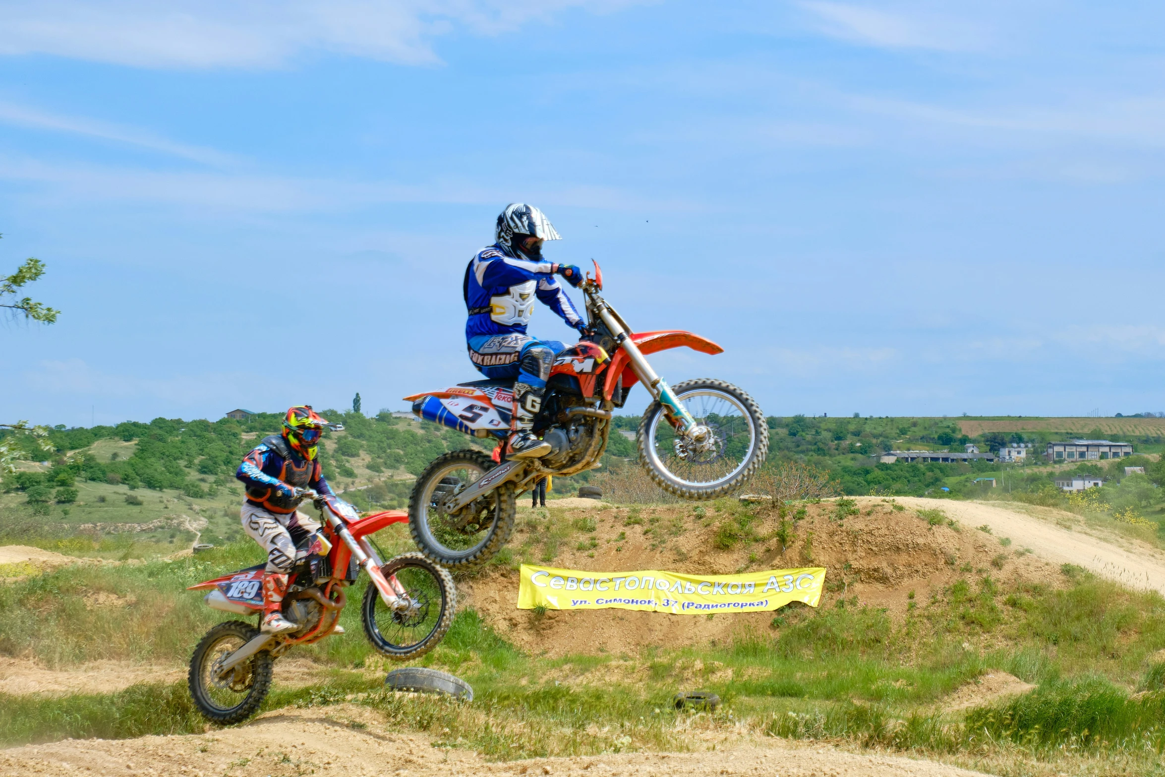 two motorcross racer are performing an off - road race