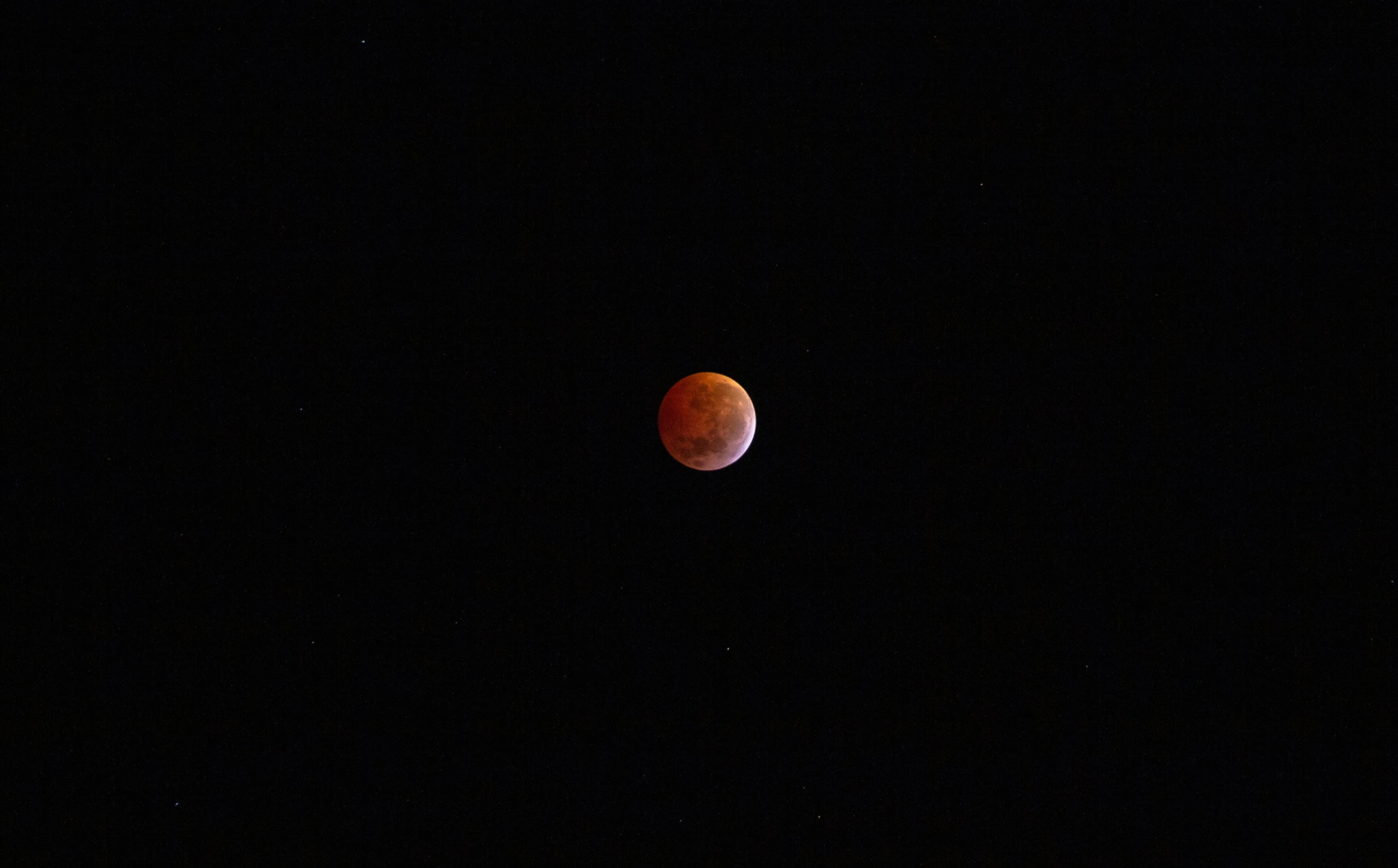 the full moon in the sky, with a dark sky background